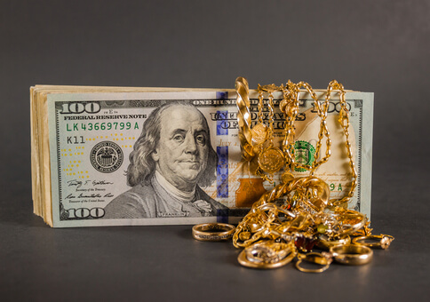 One hundred dollar bill with gold jewelry from Alliance Gold and Silver Exchange in Fort Worth, Texas